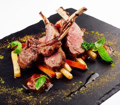 Roasted lamb rack served with carrot, yellow curry and lamb sauce Stock Photos