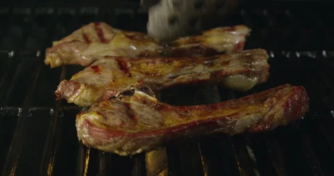 Roasted Lamb Ribs with Flames Stock Footage 243428825