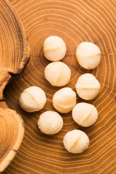 Roasted Macadamia nuts on rustic wooden background Stock Photos