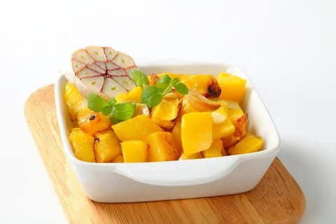 Roasted mango cubes in a white dish Stock Photos