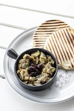 Roasted mashed Eggplant tapas snack on white table in outdoor restaurant in.. 库存照片