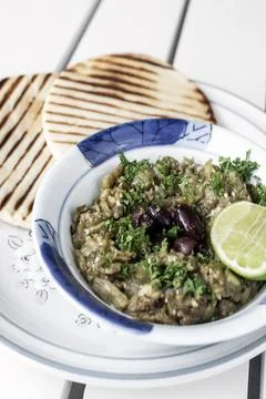 Roasted mashed Eggplant tapas snack on white table in outdoor restaurant in.. Фото