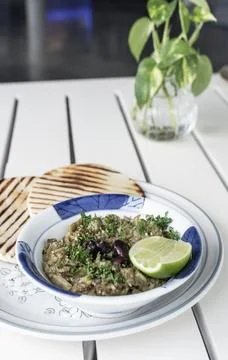 Roasted mashed Eggplant tapas snack on white table in outdoor restaurant in.. Photos