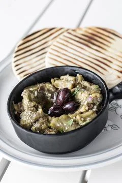 Roasted mashed Eggplant tapas snack on white table in outdoor restaurant in.. Photos