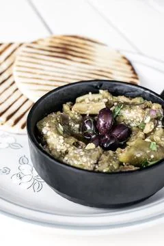 Roasted mashed Eggplant tapas snack on white table in outdoor restaurant in.. 스톡 사진