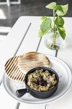 Roasted mashed Eggplant tapas snack on white table in outdoor restaurant in.. Stockfoto's