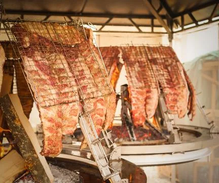 Roasted meat of beef cooked on a vertical grills. Foto stock