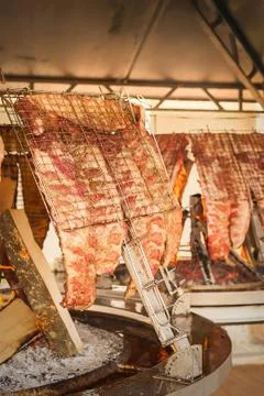 Roasted meat of beef cooked on a vertical grills. Foto stock