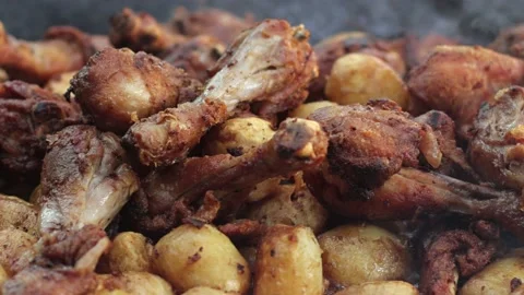 Roasted meat on fire. Fried chicken. Fried potatoes. Deliciously prepared dish. Stock Footage 205325329