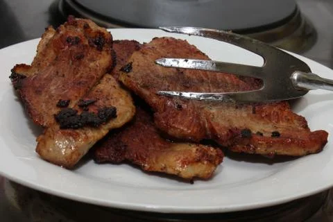 Roasted meat with meat fork Stockfoto's