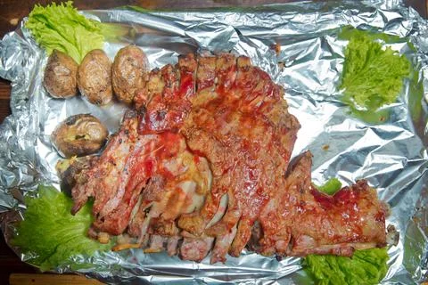 Roasted meat over an open fire, cooked in a special way.Barbecue is prepared of Stock Photos