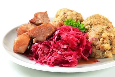Roasted meat with red cabbage and dumplings Stock Photos