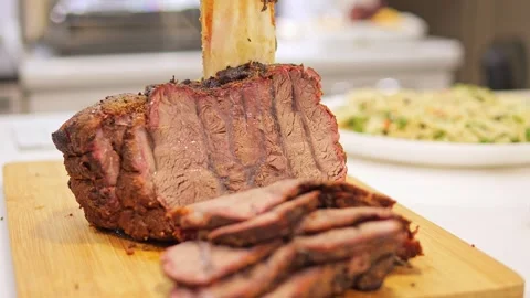 Roasted meat rests on table, tempting with its savory aroma The succulent meat Stock Footage 273122843