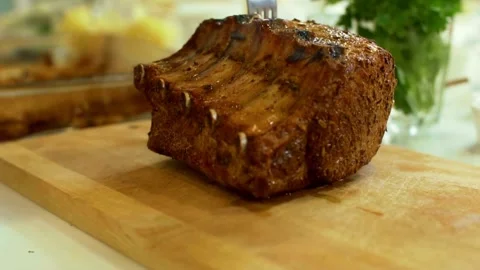 Roasted meat ribs are placed on a wooden board Video stock 333831017