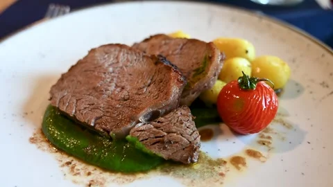 Roasted meat served in a plate with vegetables. Stock Footage 283686815