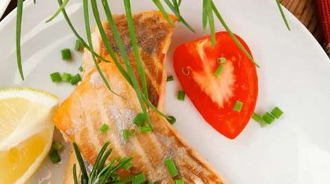 Roasted norwegian salmon chunks with lemon and vegetable salad Stock Footage 51402354