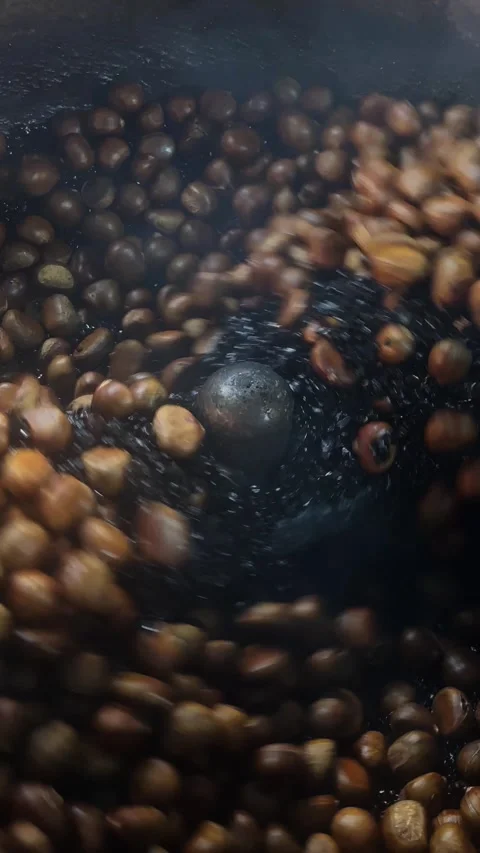 Roasted nuts spinning inside a metal roasting machine Stock Footage 317172202