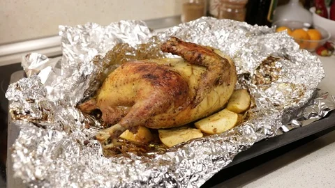 Roasted or fried chicken on foil, just cut from the oven with a knife. Homemade  Stock Footage 121330927