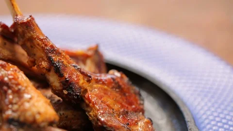 Roasted or grilled bone in lamb chops or prime rib roast B Stock Footage 120400277