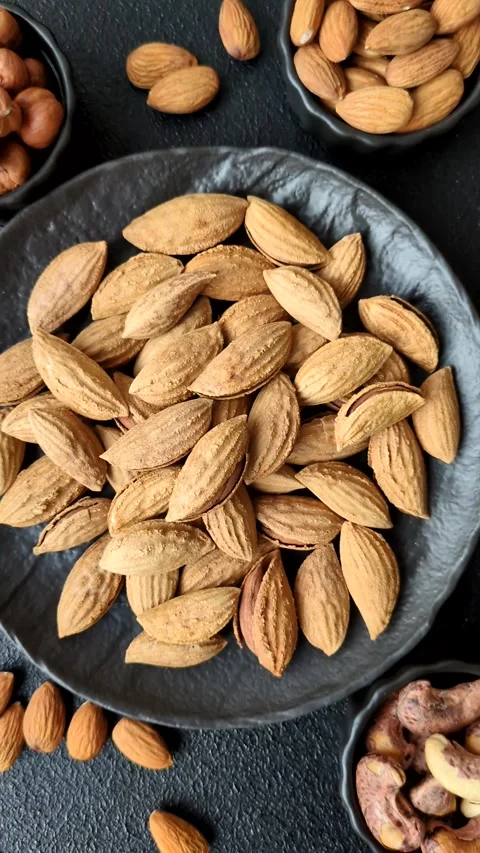Roasted or raw almond nuts in shell in bowl Stock Footage 304245536