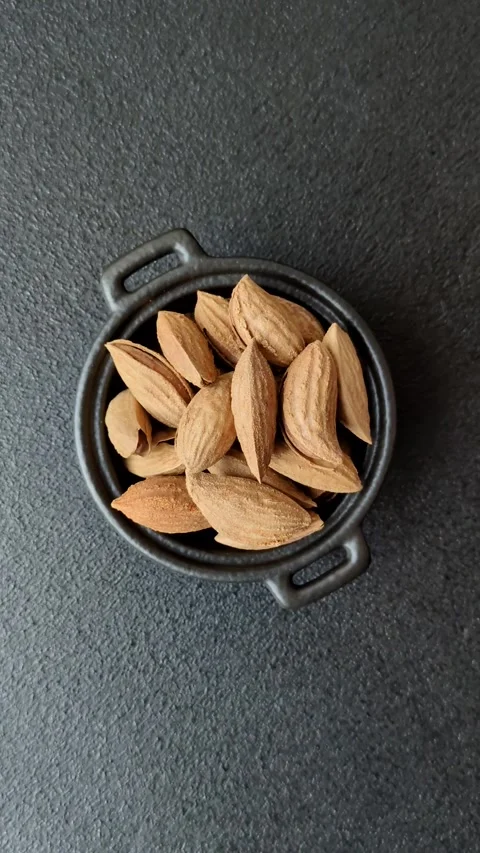 Roasted or raw almond nuts in shell in bowl Stock Footage 304245538