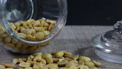 Roasted peanut in glass jar on the table Stock Footage 140230971