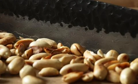 Roasted peanuts being finely chopped with a knife. 写真素材
