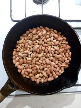 Roasted peanuts in a pan on a white background Stock Photos