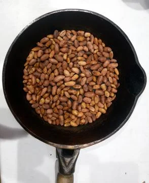 Roasted peanuts in a pan on a white background Stock Photos