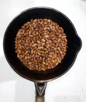 Roasted peanuts in a pan on a white background Stock Photos