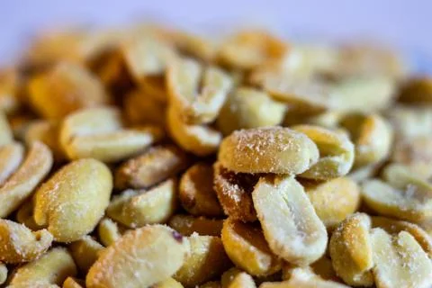 Roasted peanuts with salt coating in a pile 写真素材