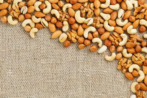 Roasted peanuts in the shell and peeled in a cup, against a gray wooden table Фото