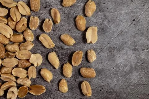 Roasted peanuts on a slate table.  Stock Photos
