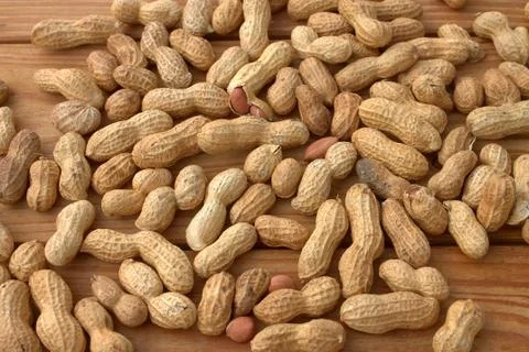 Roasted peanuts on wood texture background. Stock Photos