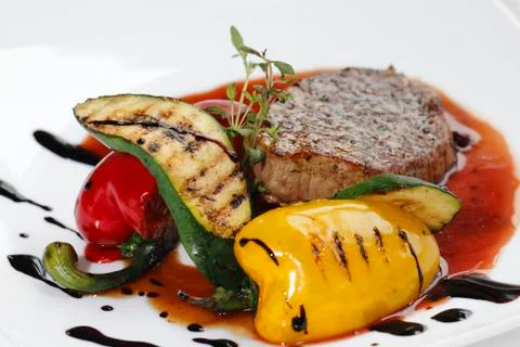 Roasted piece of meat with vegetables Stock Photos