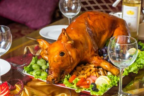 Roasted pig on rich table in eastern restaurant Stock Photos