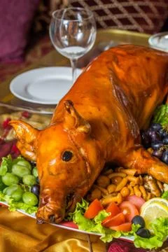 Roasted pig on rich table in eastern restaurant Stock Photos