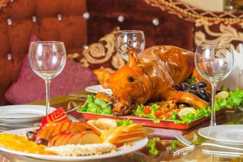 Roasted pig on rich table in eastern restaurant Stock Photos