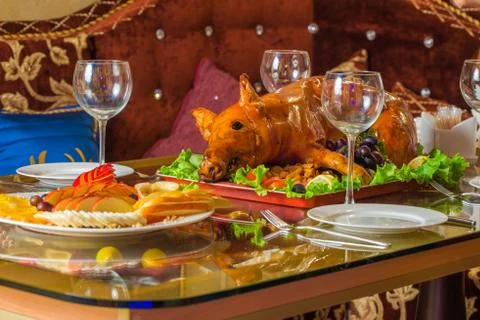 Roasted pig on rich table in eastern restaurant Stock Photos