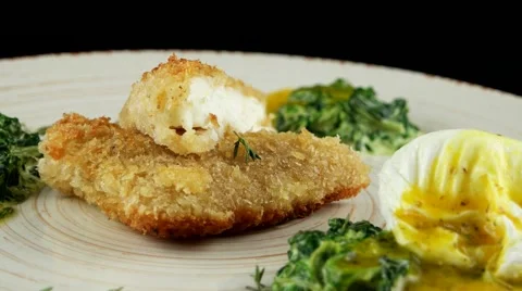 Roasted pikeperch fillet with soft poached egg and spinach, closeup, loop Stock Footage 66482339
