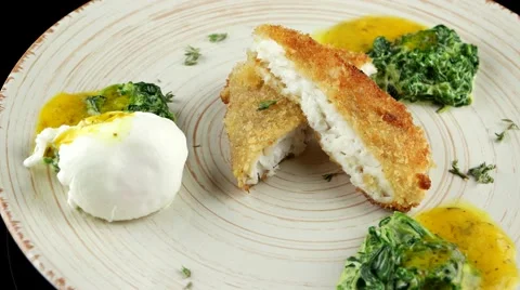 Roasted pikeperch fillet with soft poached egg and spinach Stock Footage 66482354