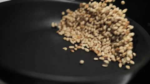 Roasted pine nuts tossing in a frying pan. Stock Footage 171462821
