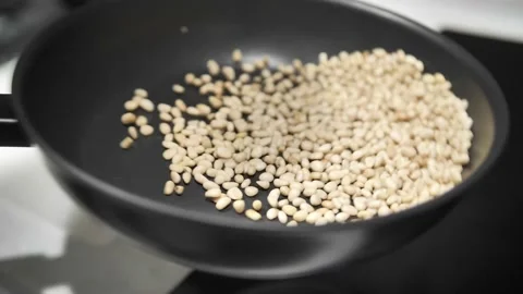 Roasted pine nuts tossing in a frying pan. Stock Footage 171462828
