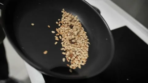 Roasted pine nuts tossing in a frying pan. Stock Footage 171462925