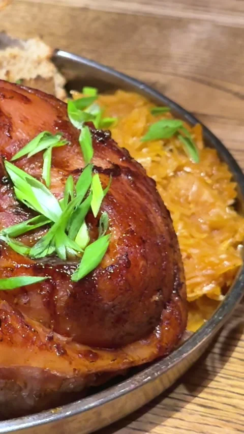 Roasted pork ham slices with potato and cabbage and pork knuckle deep fried with Stock Footage 322661453