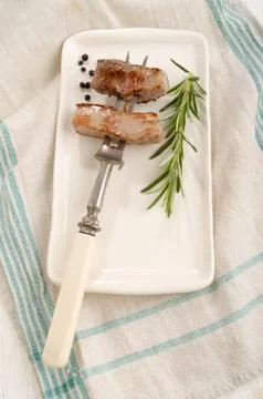 Roasted pork meat on a fork Stock Photos