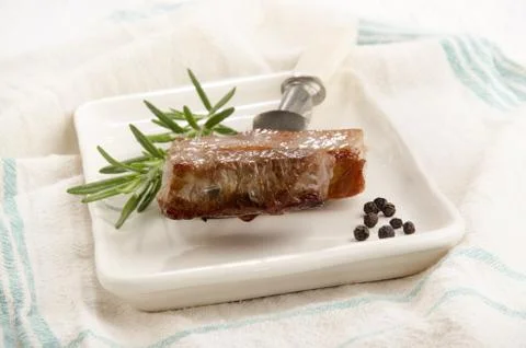 Roasted pork meat on a fork Stock Photos