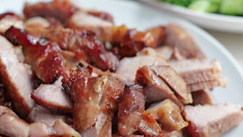 Roasted Pork Slice with Crispy Caramelized Skin, Broccoli, and Golden Side Dish Stock Footage 346328346