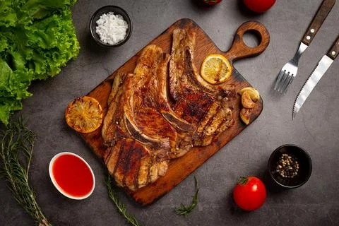 Roasted pork steak on the dark background. Stock Photos