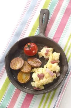 Roasted potato with scrambled egg Stock Photos